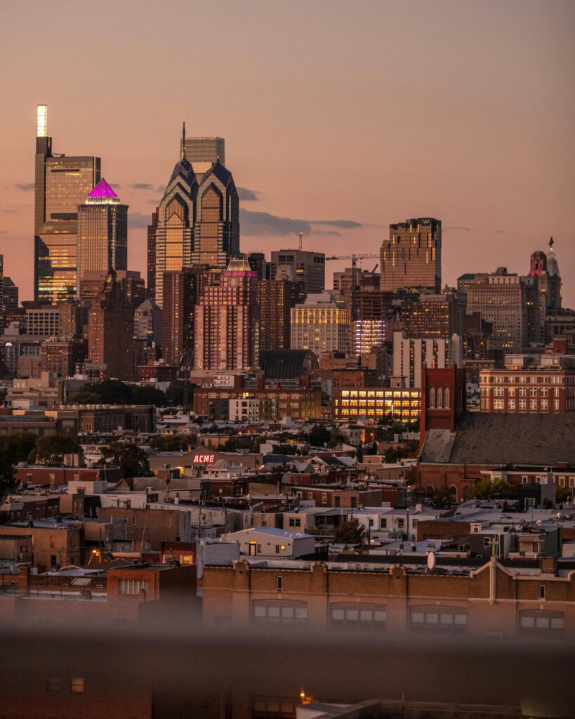 A breathtaking view of downtown Philadelphia skyline against a sunset backdrop.