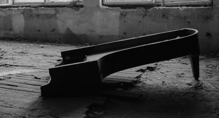 A haunting black and white image of a broken piano in an abandoned building in Rozdil, Ukraine.