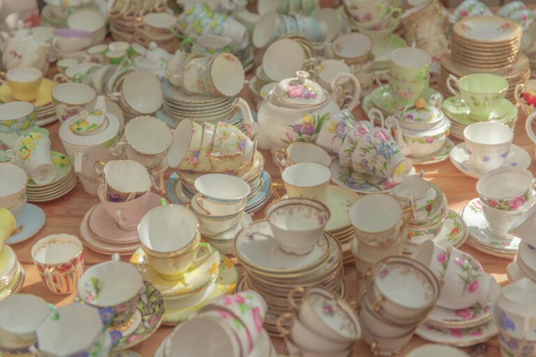 A vibrant assortment of vintage ceramic tea sets with a floral theme, showcasing delicate porcelain craftsmanship.