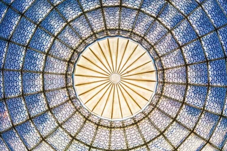 A vibrant geometric stained glass dome with intricate patterns, captured from below in Jakarta, Indonesia.