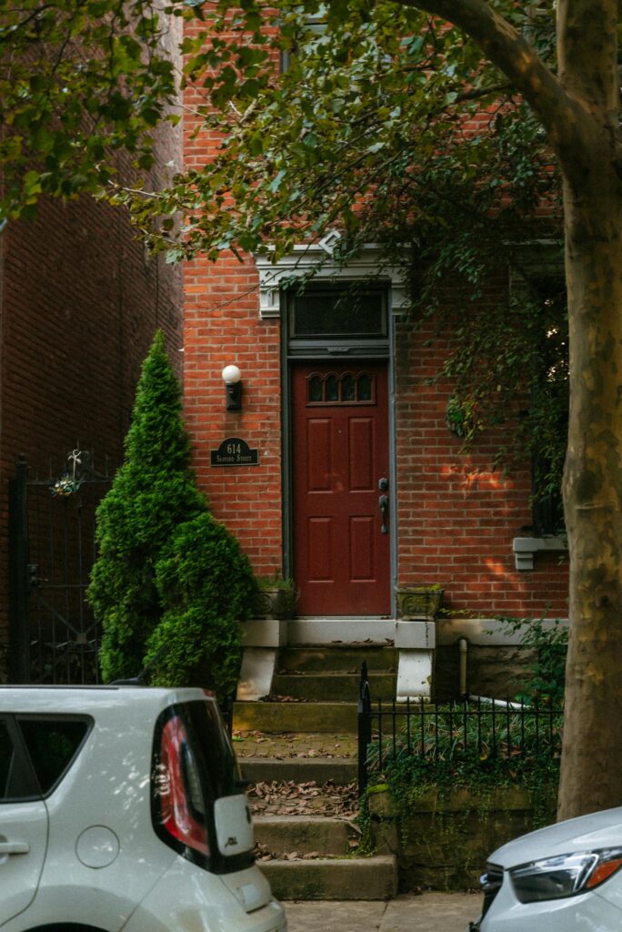 Entrance to a historic brick house in Cincinnati with autumn foliage.