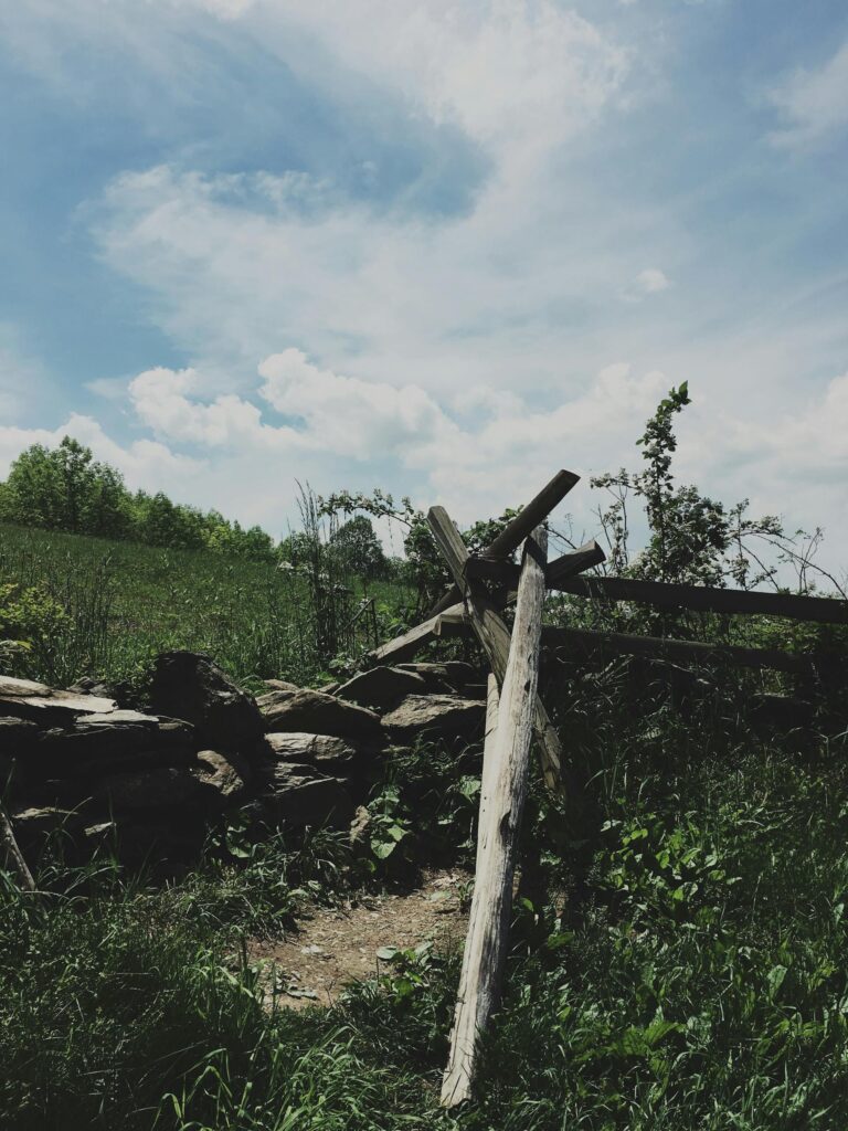 Scenic view of rural Afton, Virginia with countryside fence and green fields under a blue sky.