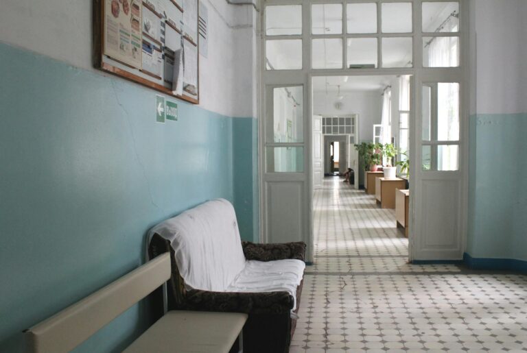 An empty vintage hospital corridor with classic furniture and potted plants in Ukrainka.