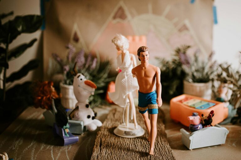 Newlywed couple of dolls holding hands at romantic wedding ceremony with guests sitting in audience